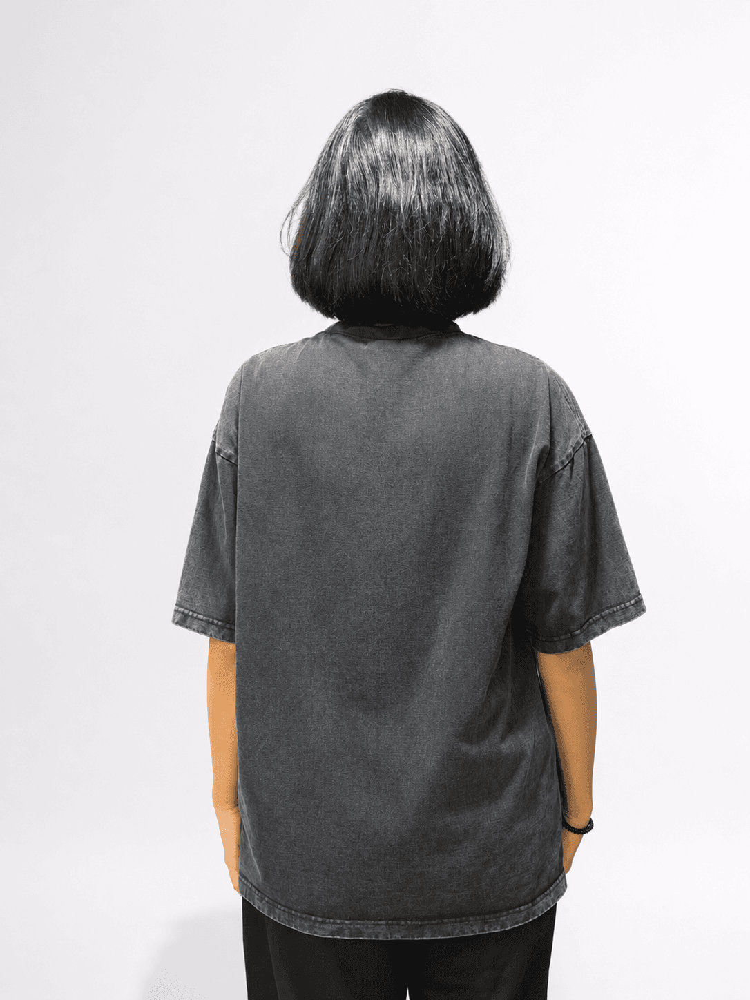 Black Acid Washed Oversized T-Shirt — model wearing tee, back view